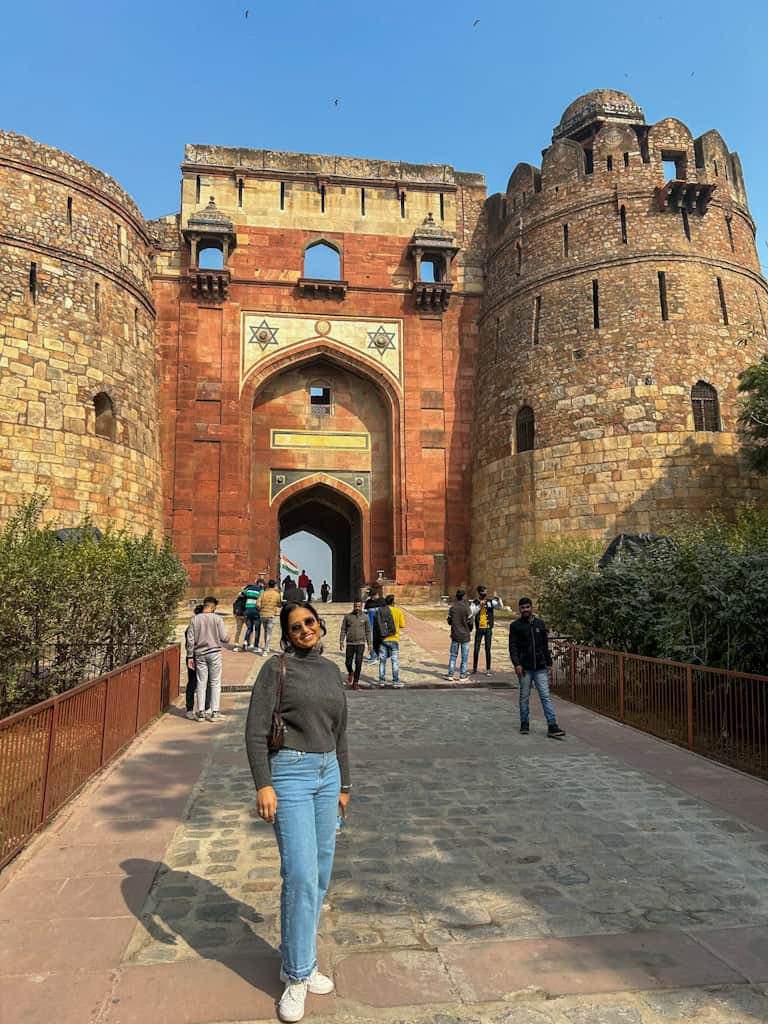 Packing for cold weather in India – traveller with warm jumper, jeans and thermal wear