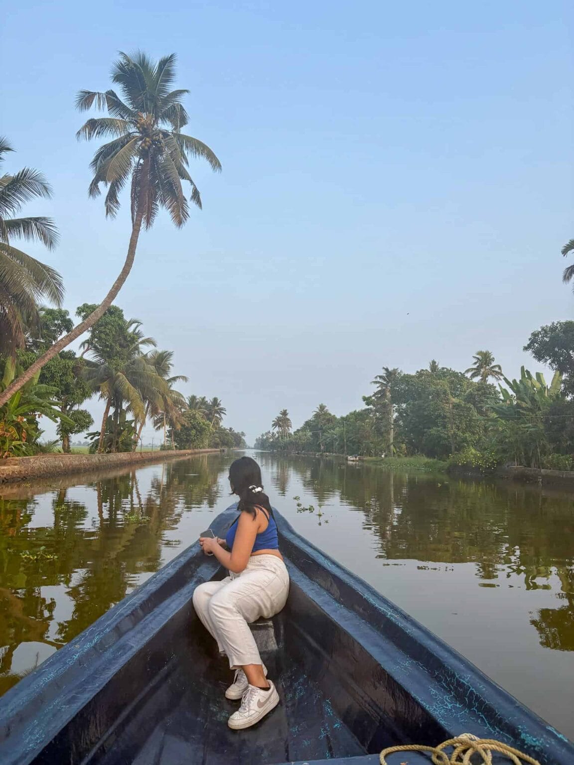 Exploring narrow canals in Alleppey in the Kerala Backwaters